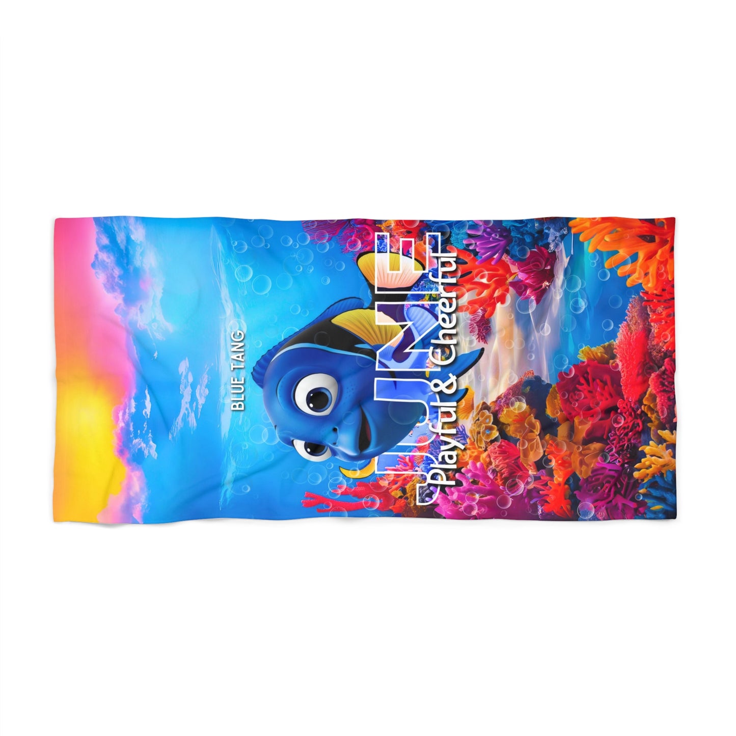 Colorful birth month kids beach towel featuring a blue tang fish and vibrant coral reef design