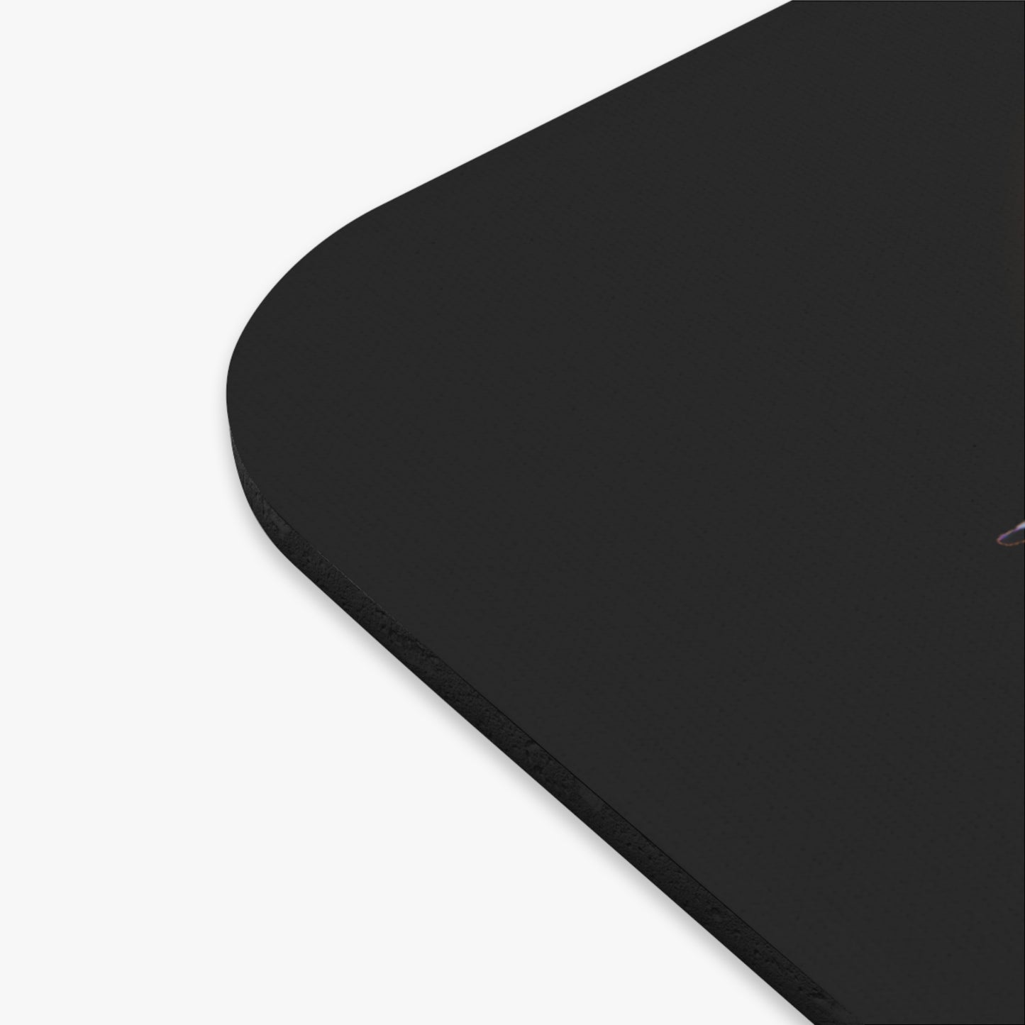 Close-up of black birth month mouse pad corner with smooth rounded edges
