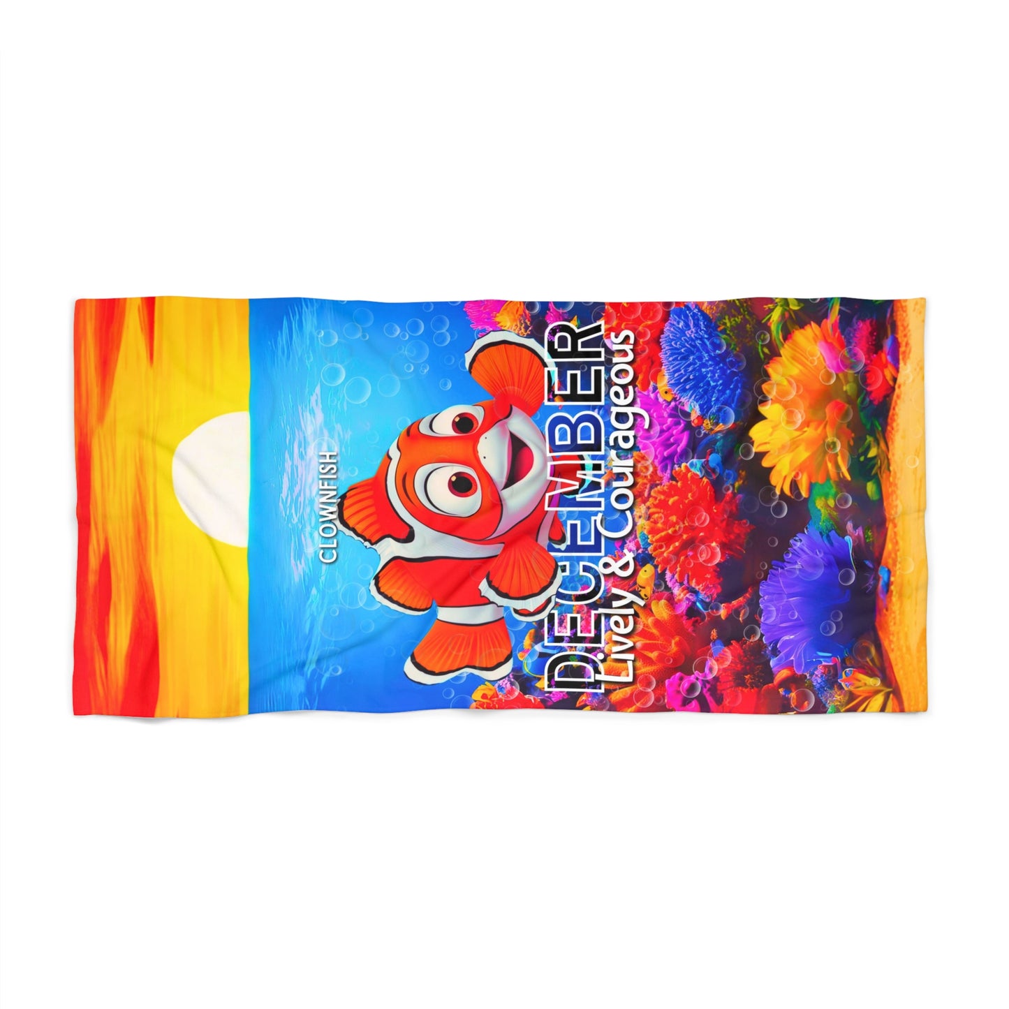 December birth month kids beach towel featuring a colorful clownfish and vibrant coral reef design