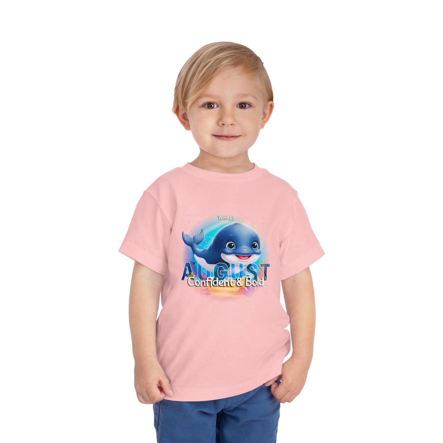 Toddler wearing pink August kids birth month tshirt with blue whale graphic and confident bold text