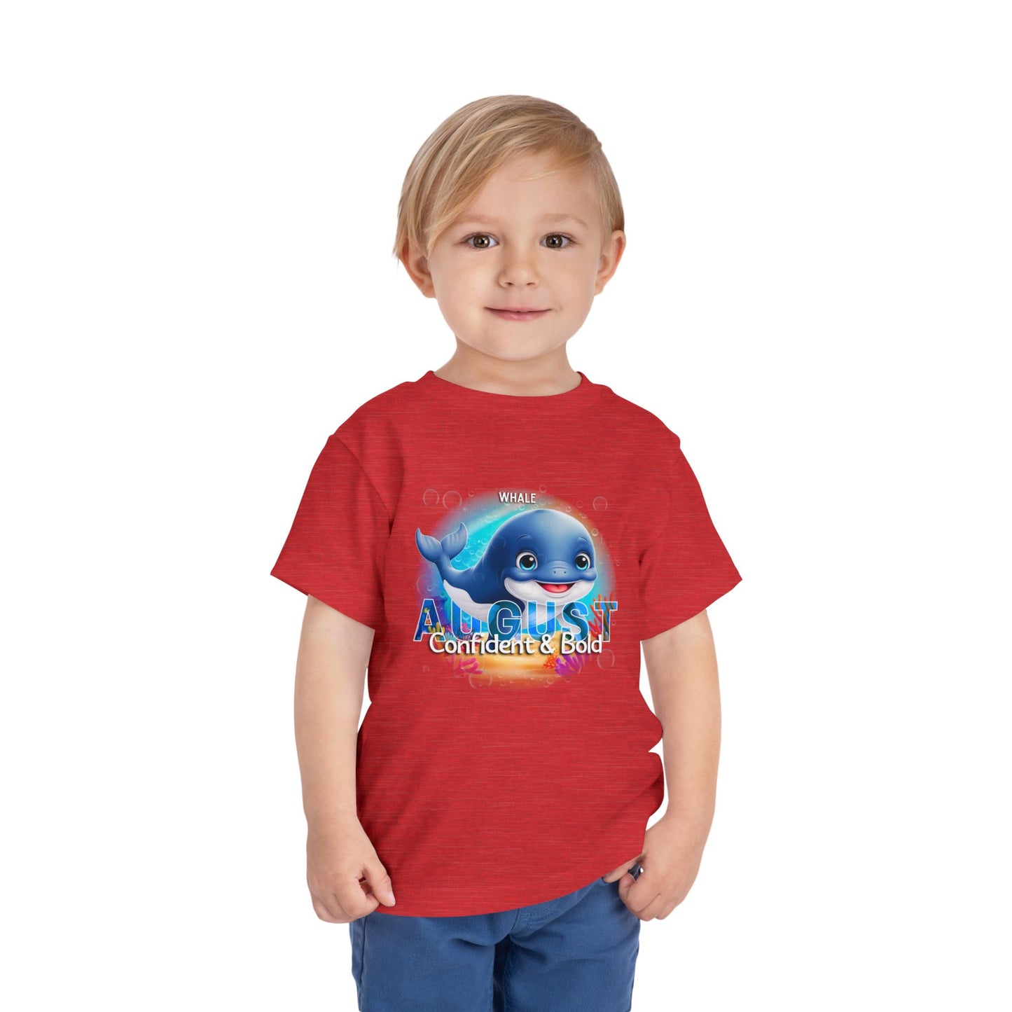 Toddler wearing a red kids birth month tshirt with August whale design and confident bold text