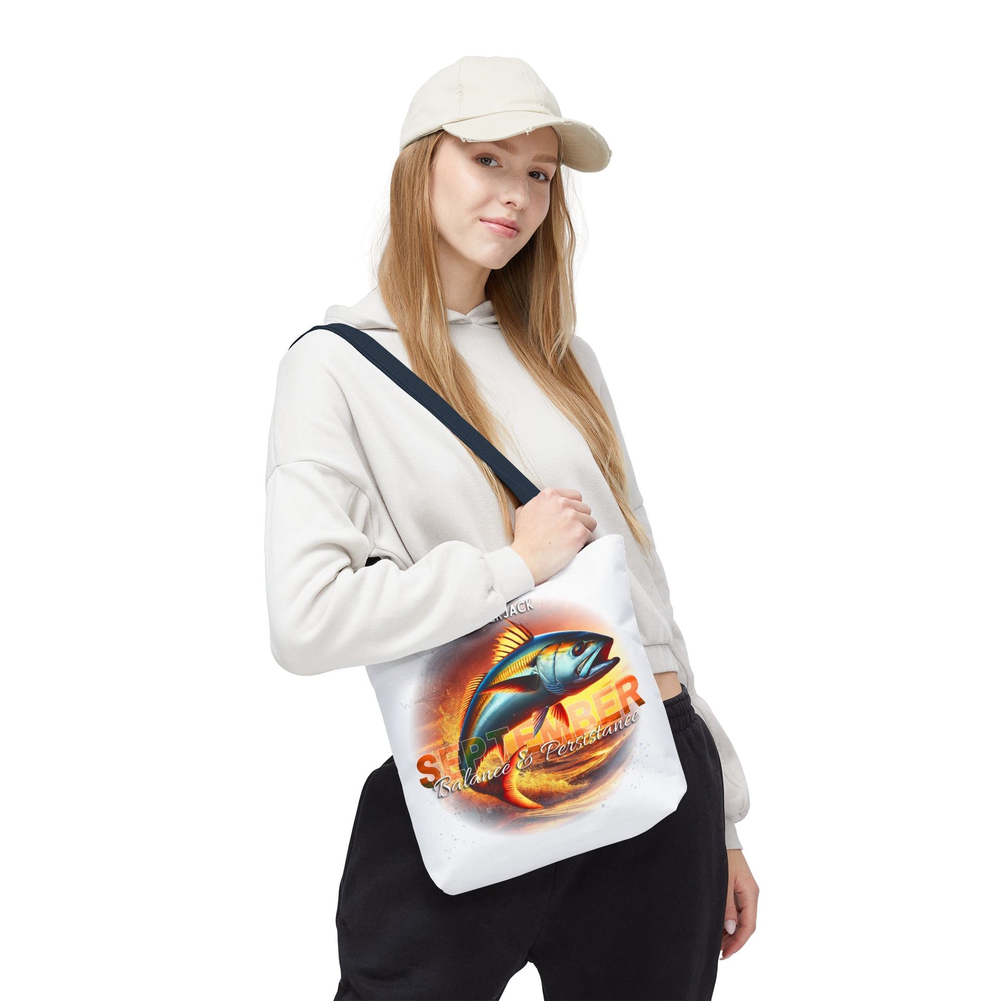 Birth month beach tote featuring colorful fish design worn by woman in casual outfit