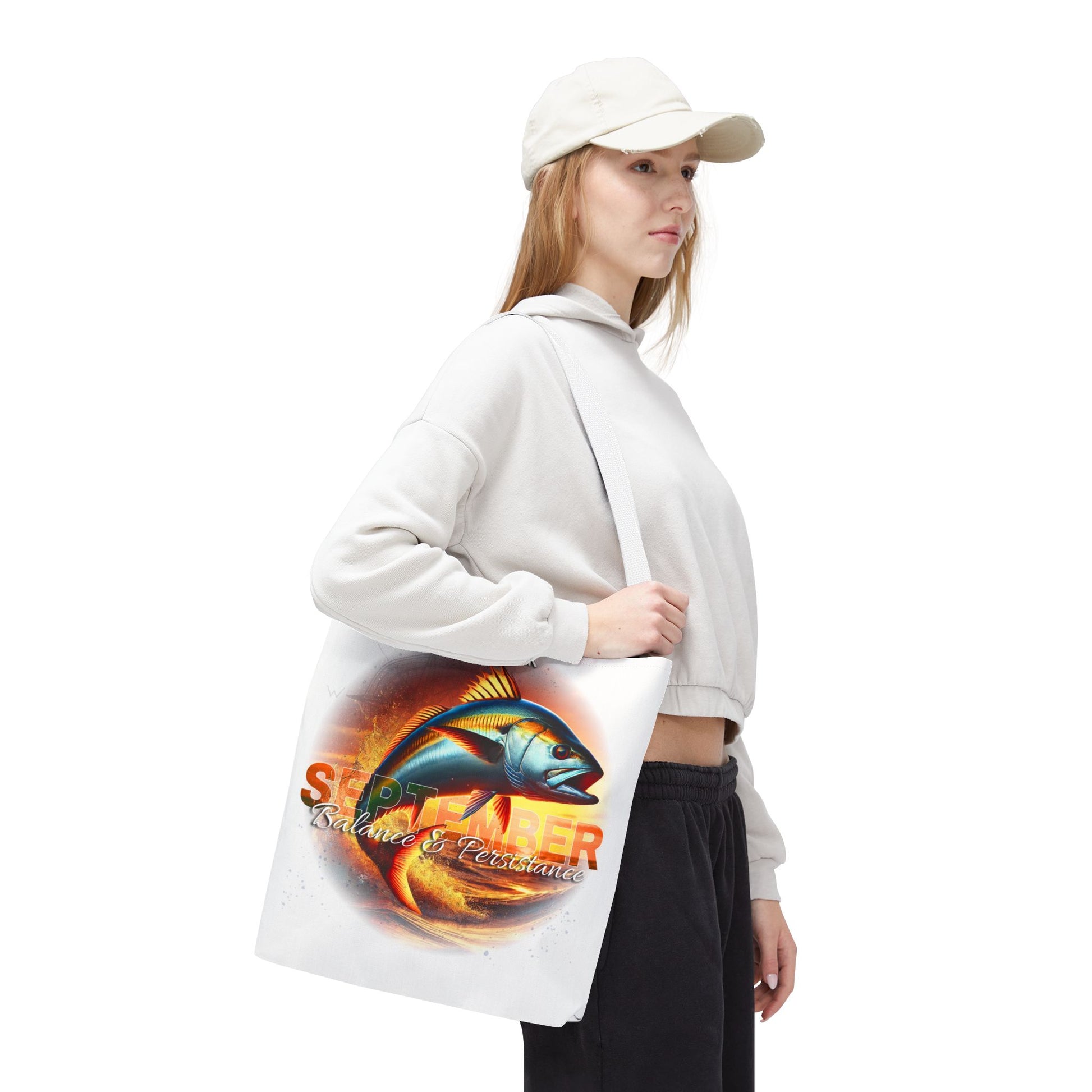Woman carrying a birth month beach tote featuring a vibrant fish design and September text