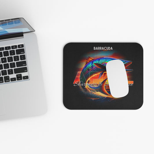 Birth month mouse pad featuring colorful barracuda design next to a laptop