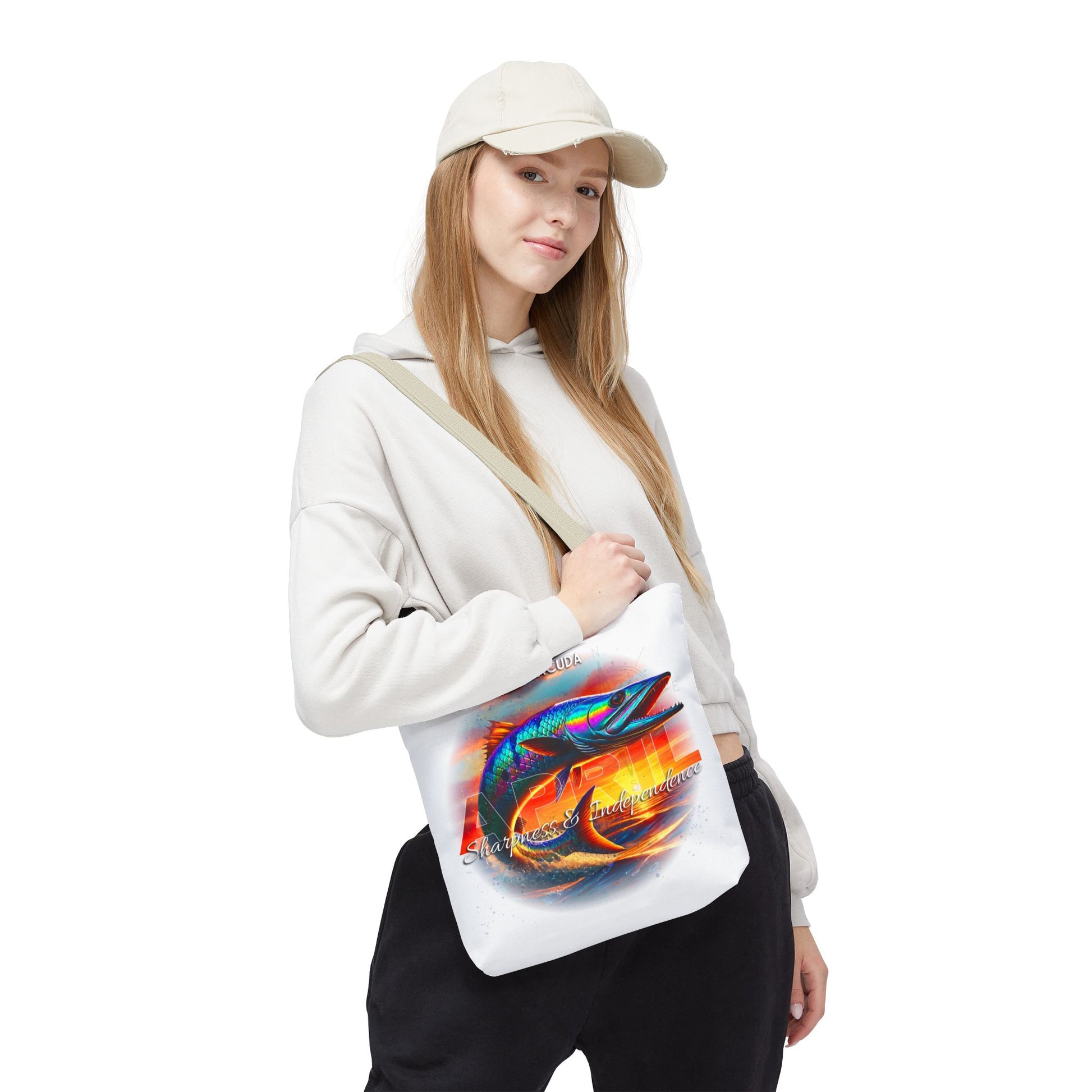 Woman wearing white hoodie and cap carrying a birth month beach tote with colorful fish design