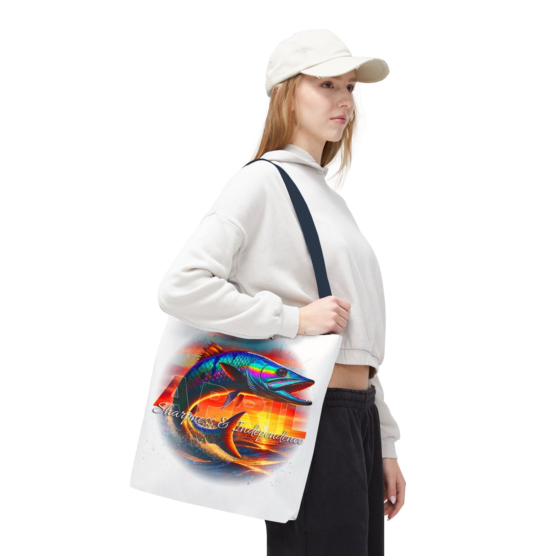 Woman carrying a birth month beach tote with colorful fish design and black straps
