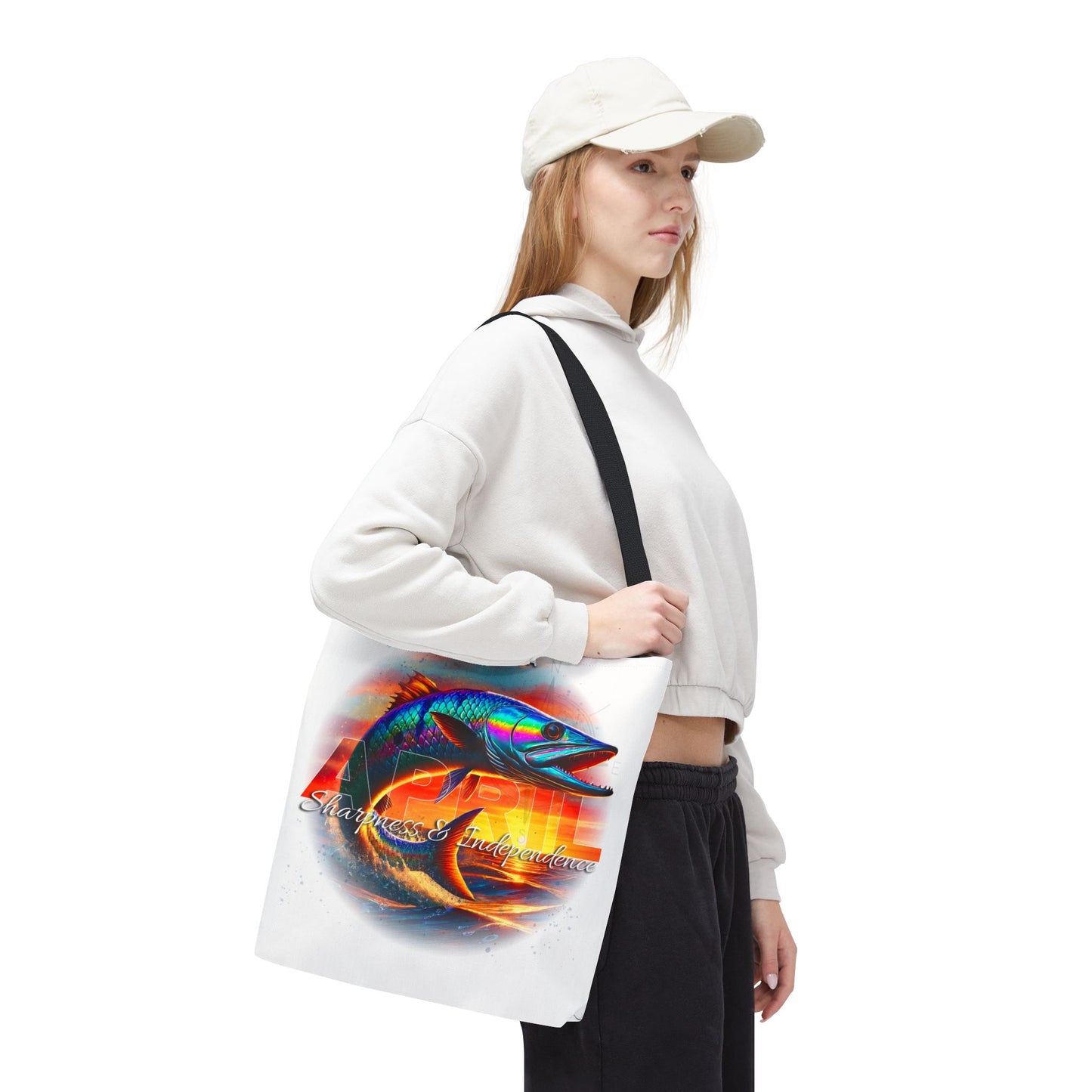 Woman carrying birth month beach tote with colorful fish design and black strap