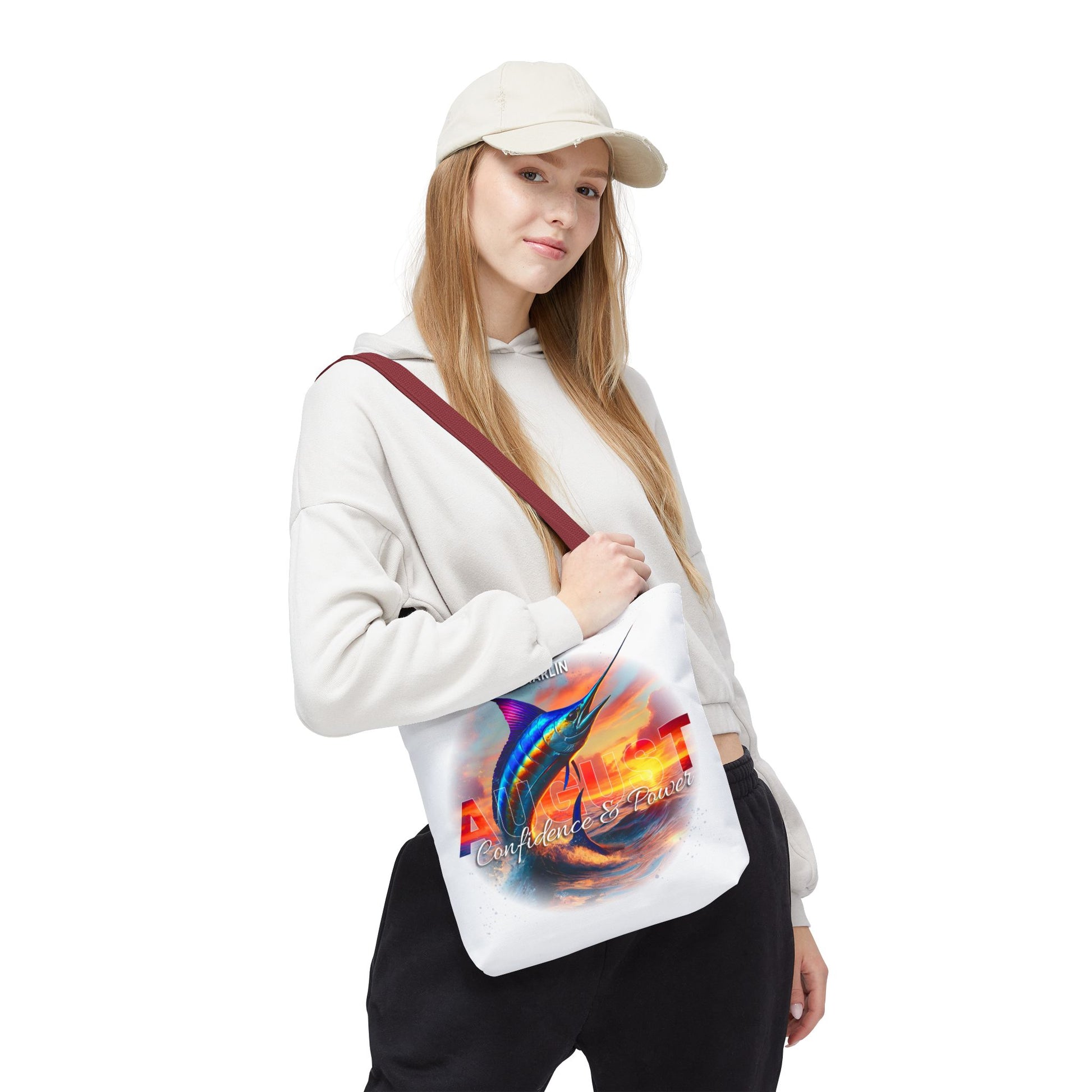 Woman wearing a birth month beach tote with colorful fish design and scenic background