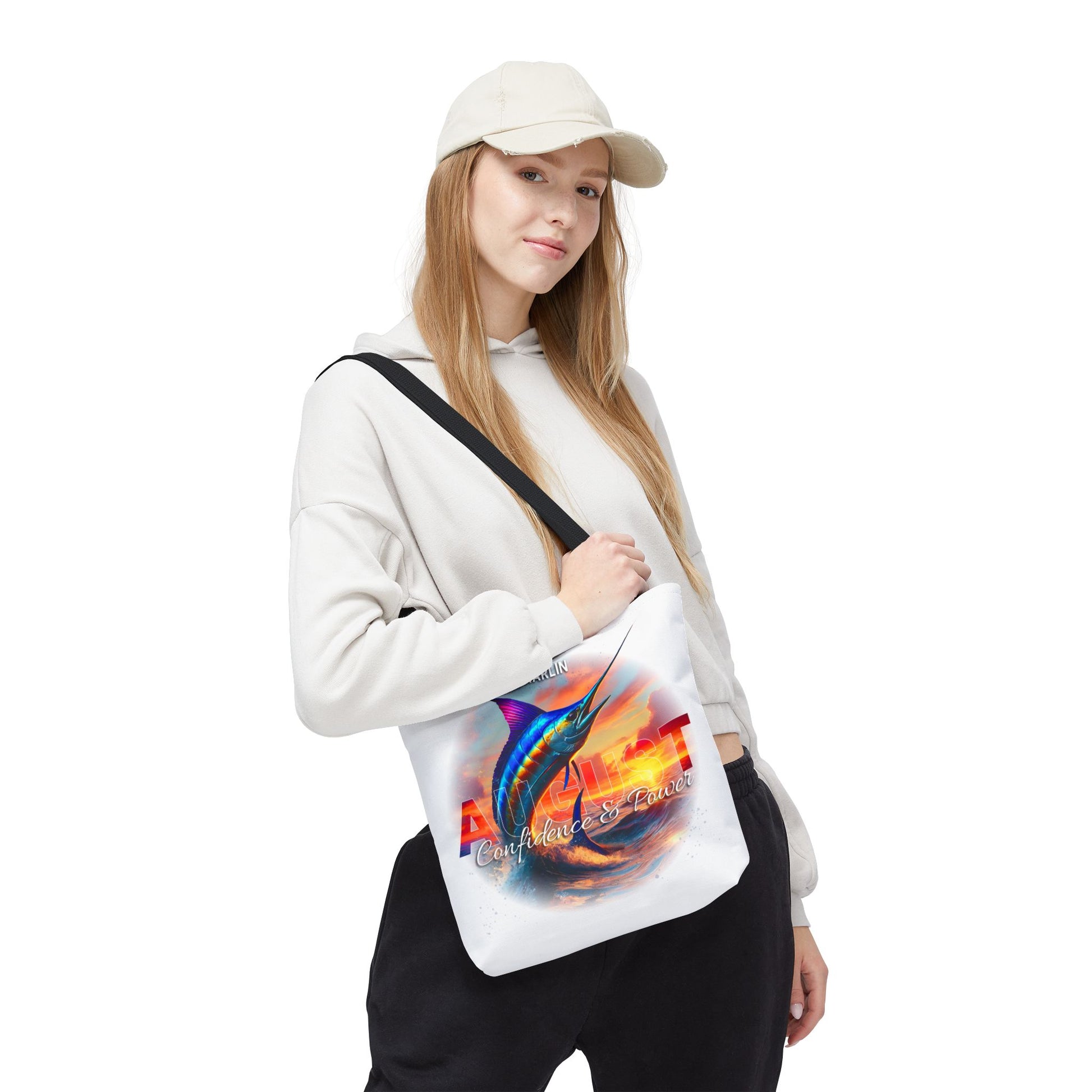 Woman wearing casual outfit carrying a colorful birth month beach tote with marlin fish design