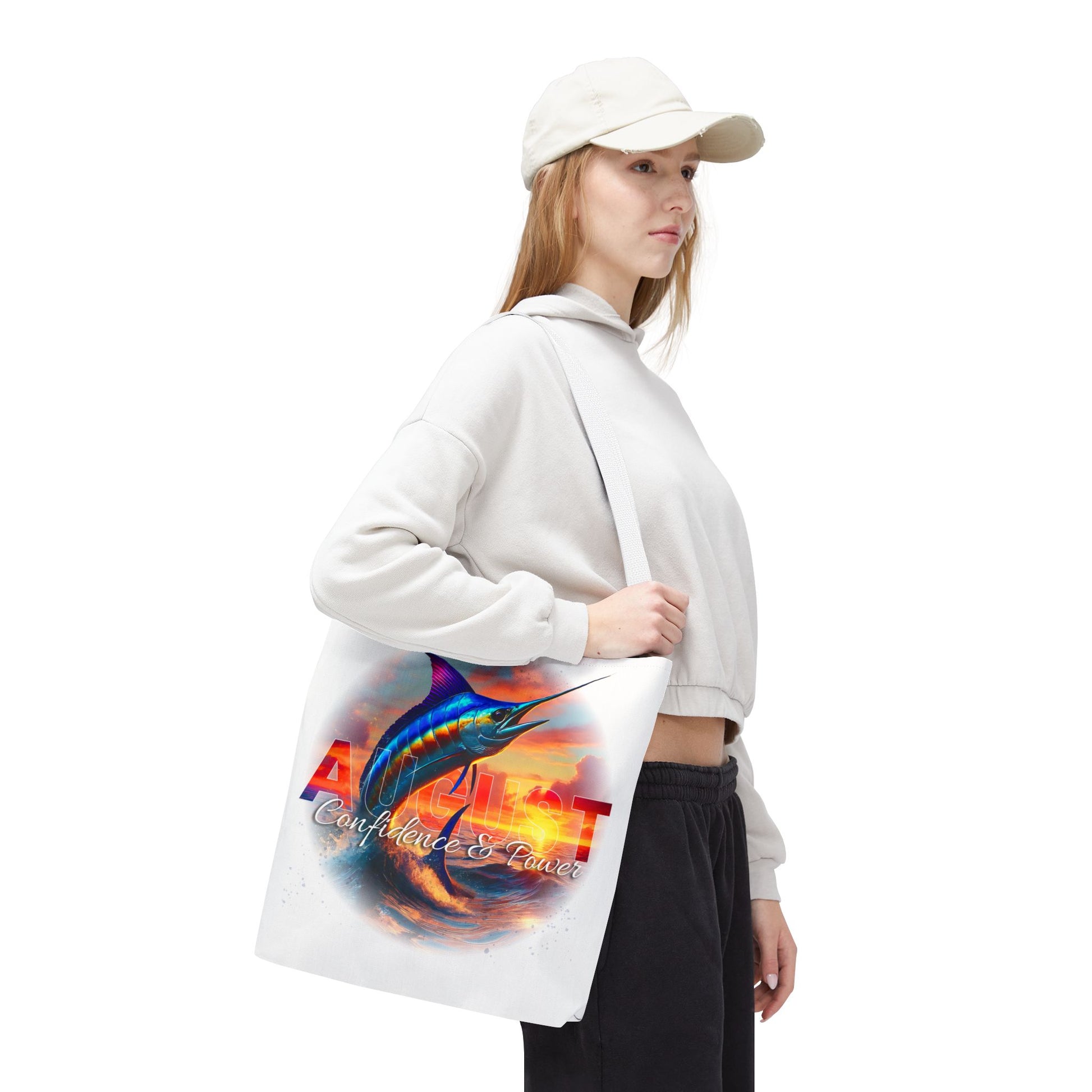 Woman carrying a birth month beach tote featuring a vibrant marlin and August design