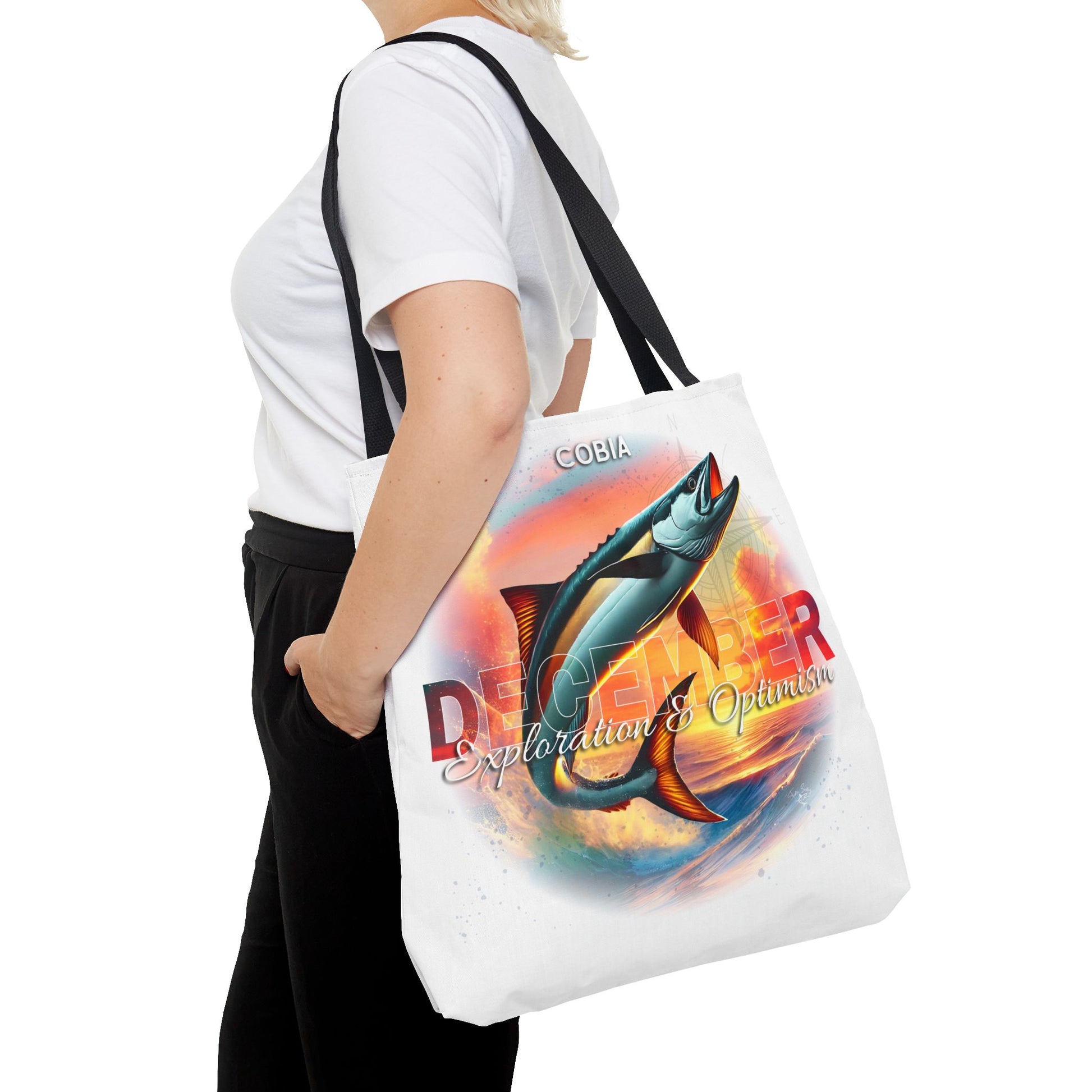 Birth month beach tote with colorful fish design and December text carried by woman