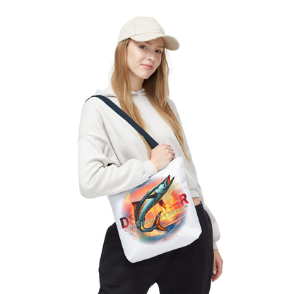 Birth month beach tote with colorful fish design worn by woman in casual outfit