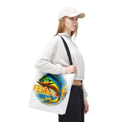 Woman carrying birth month beach tote with colorful February fish design and black straps