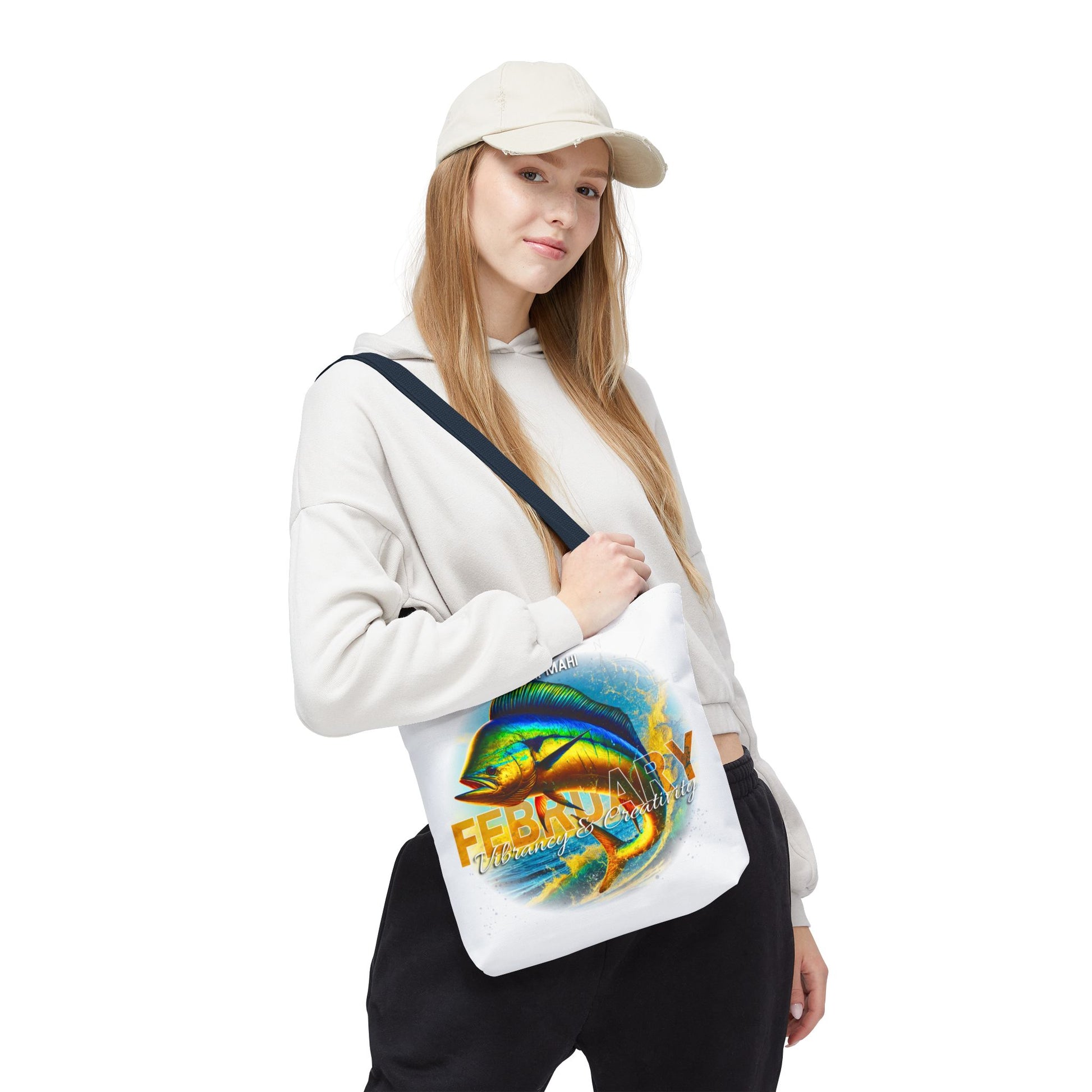 Woman wearing a white birth month beach tote with colorful February fish design 