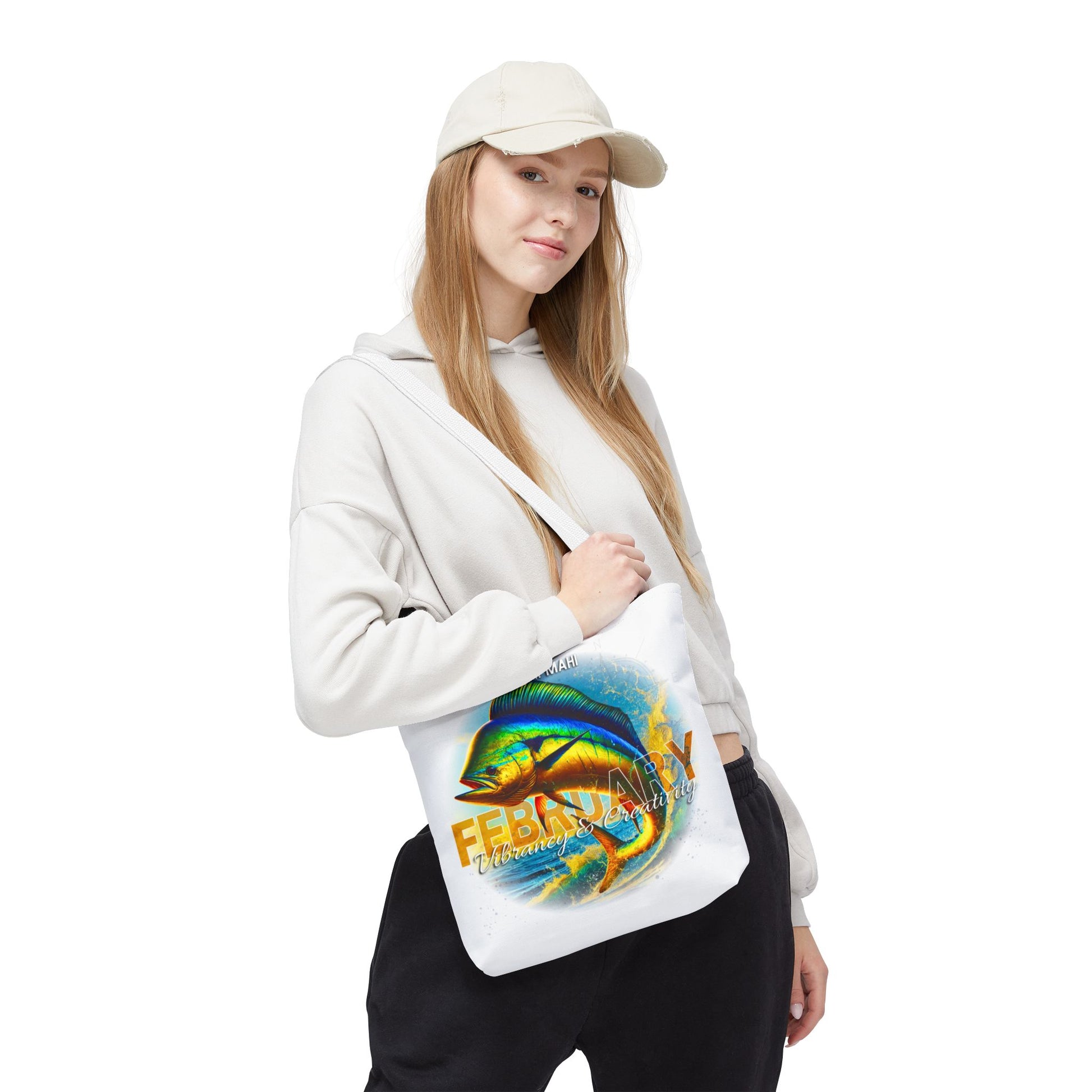 Young woman wearing a white birth month beach tote with colorful fish and February design