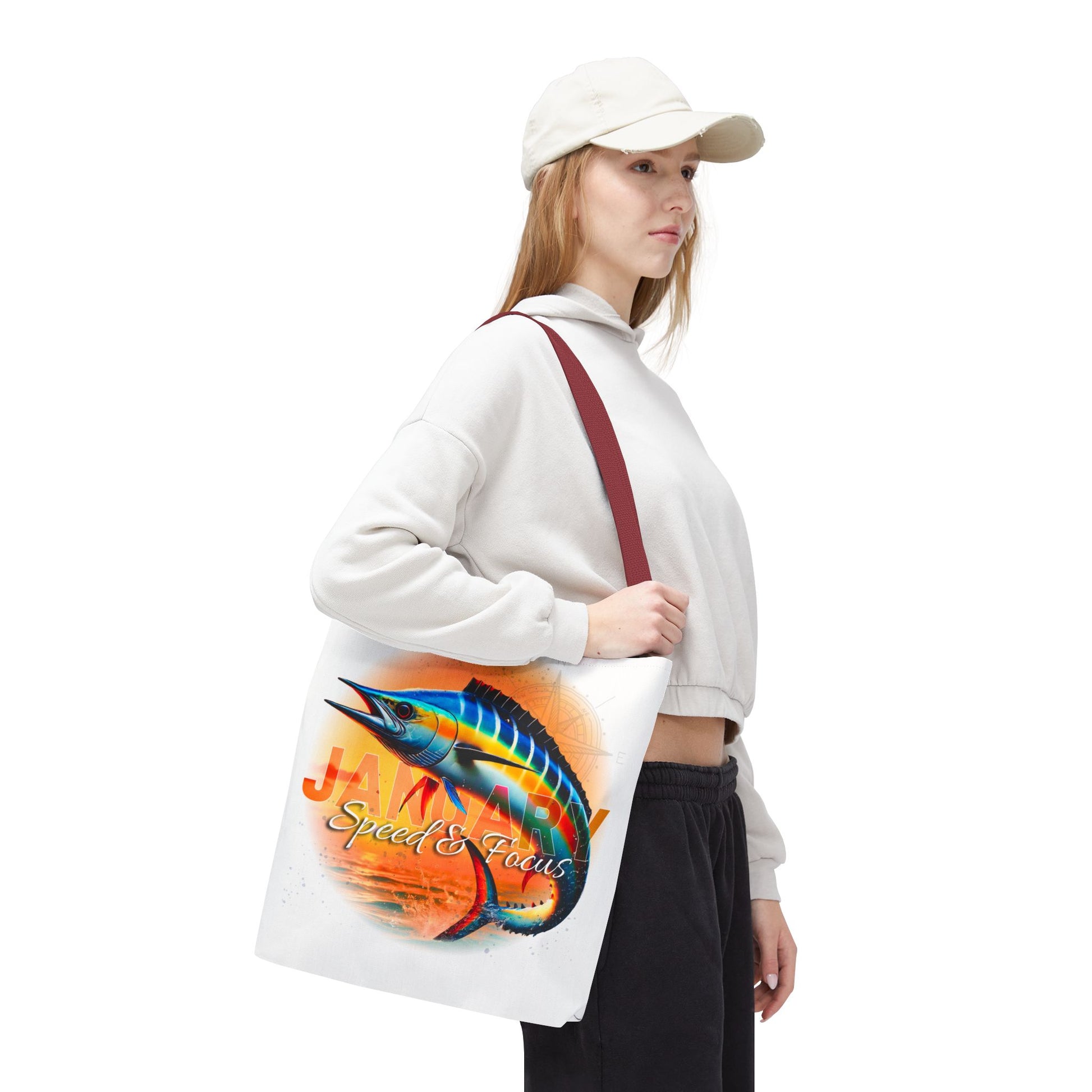 Woman carrying birth month beach tote with colorful marlin fish design and red strap