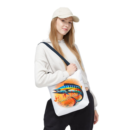 Birth month beach tote with colorful fish design worn by woman in casual outfit