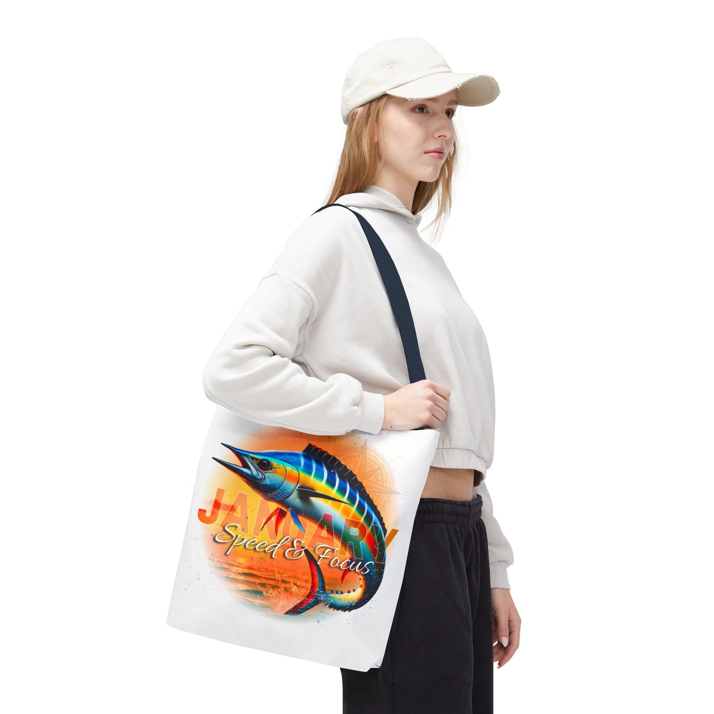 Birth month beach tote featuring colorful marlin fish design carried by woman wearing casual white cap and sweater