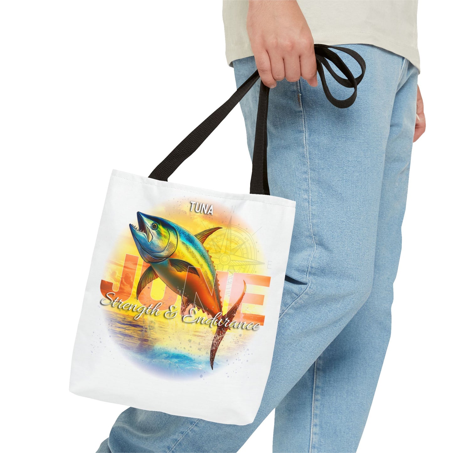 Birth month beach tote with tuna fish design held by person wearing jeans