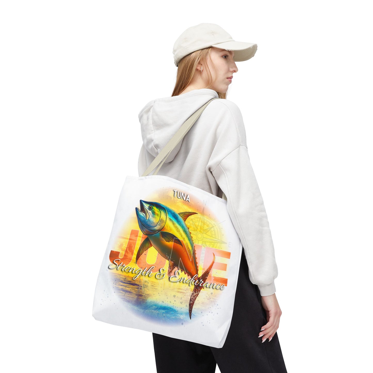 Birth month beach tote with colorful tuna fish design carried by a woman in casual outfit