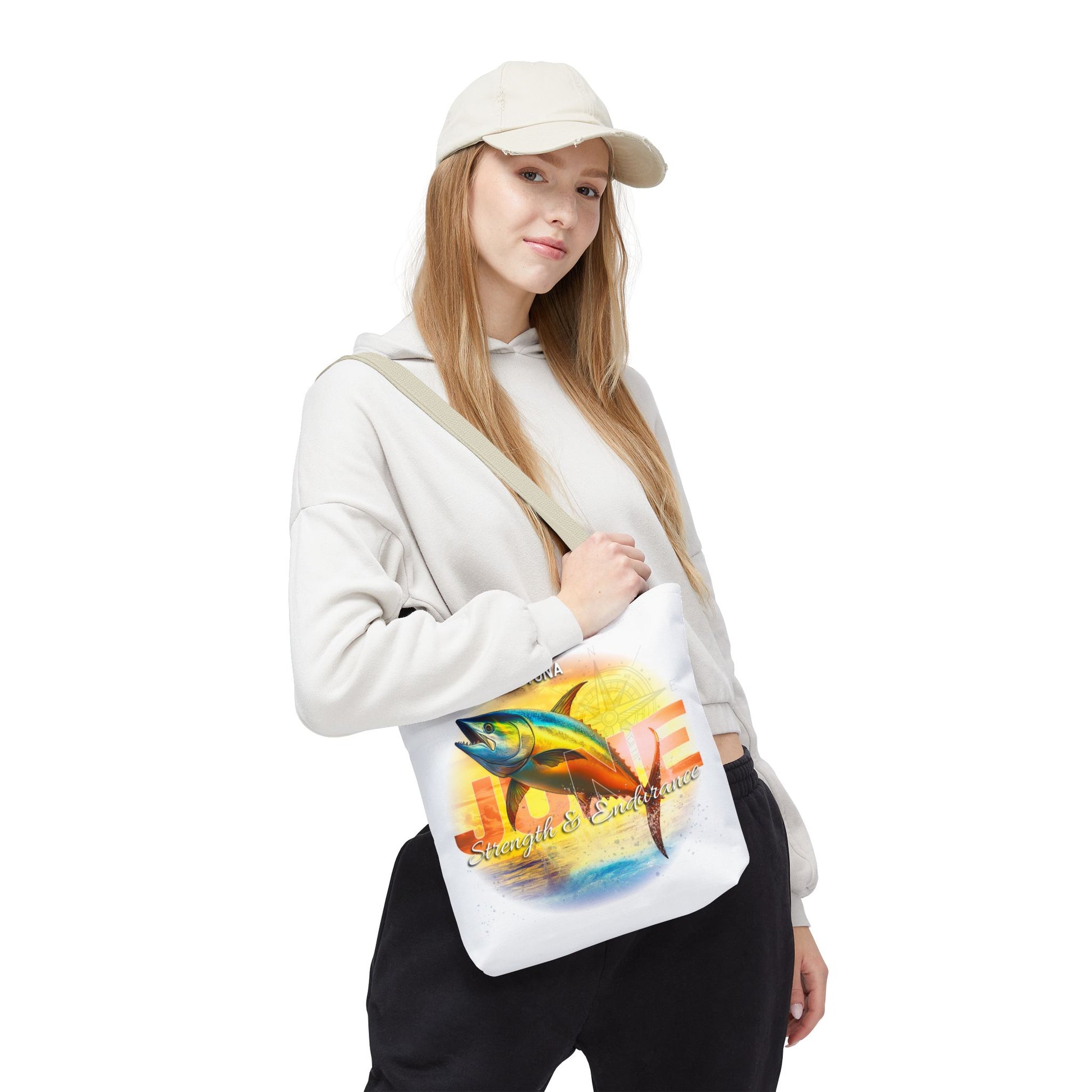 Woman wearing a white birth month beach tote with a colorful fish design over her shoulder