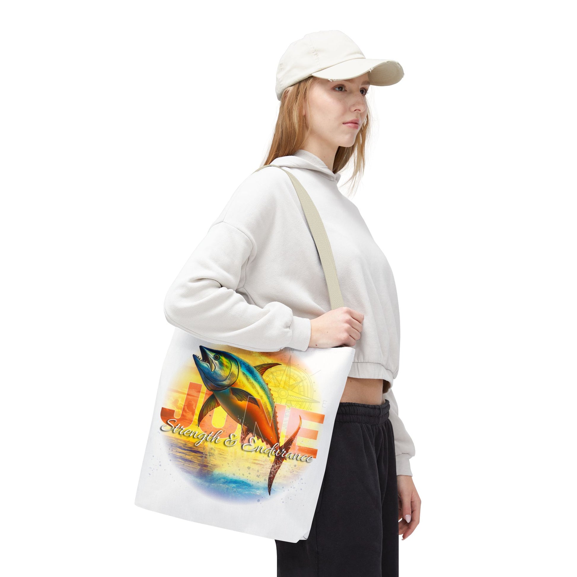 Woman carrying a birth month beach tote featuring a colorful fish and inspirational text
