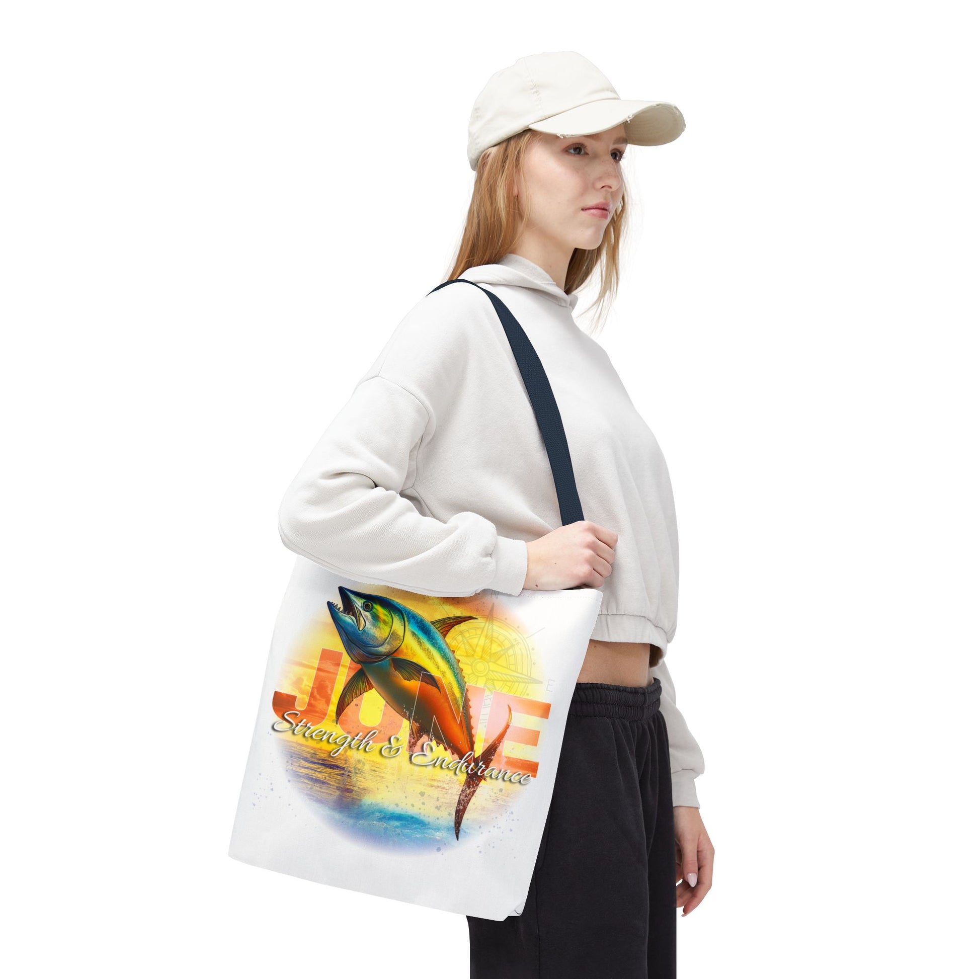 Woman carrying a birth month beach tote with colorful tuna fish design and strength theme