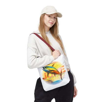 Woman carrying birth month beach tote with colorful fish and sunset design