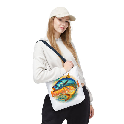 Woman wearing white cap and hoodie carrying a white birth month beach tote with colorful fish design