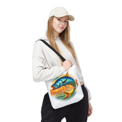 Woman wearing white cap and hoodie carrying birth month beach tote with colorful fish design