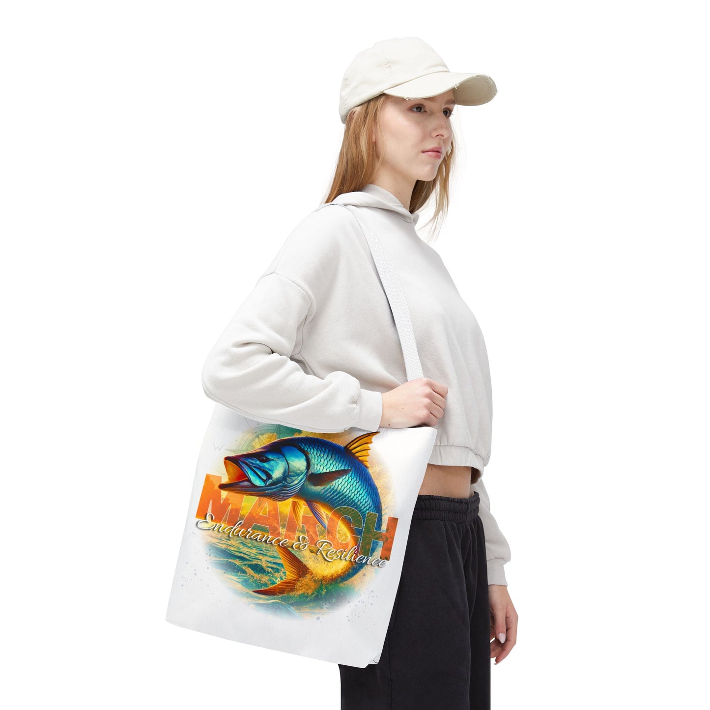 Woman wearing a white birth month beach tote with colorful March fish design and text