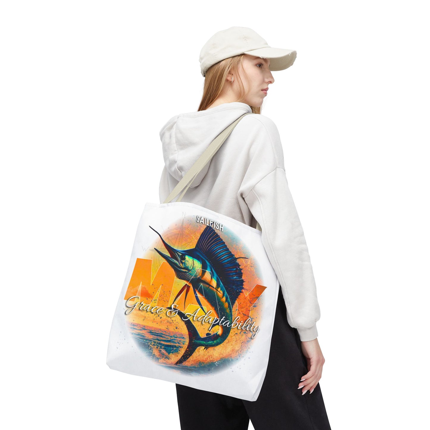 Birth month beach tote with colorful sailfish design carried by woman in casual outfit
