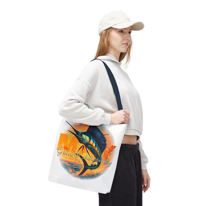 Birth month beach tote with colorful marlin fish design carried by woman in casual outfit