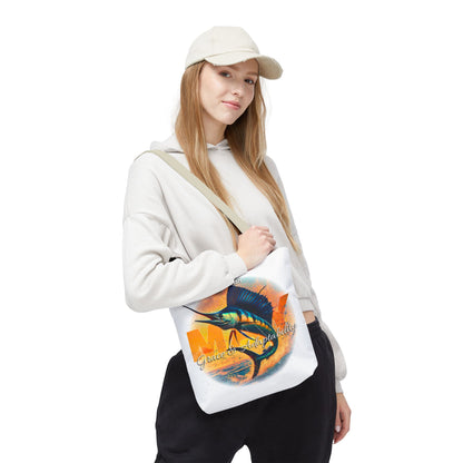 Woman wearing casual outfit carrying a birth month beach tote with colorful fish design 