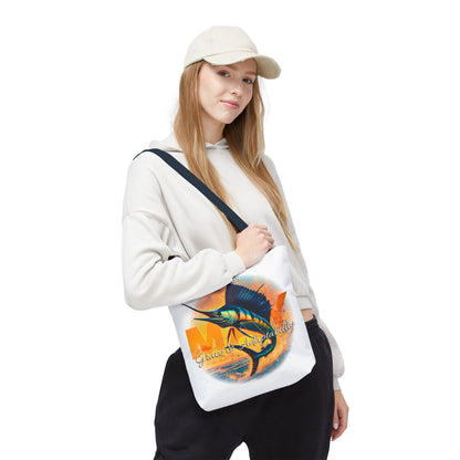 Woman wearing a casual outfit carrying a birth month beach tote with colorful fish design