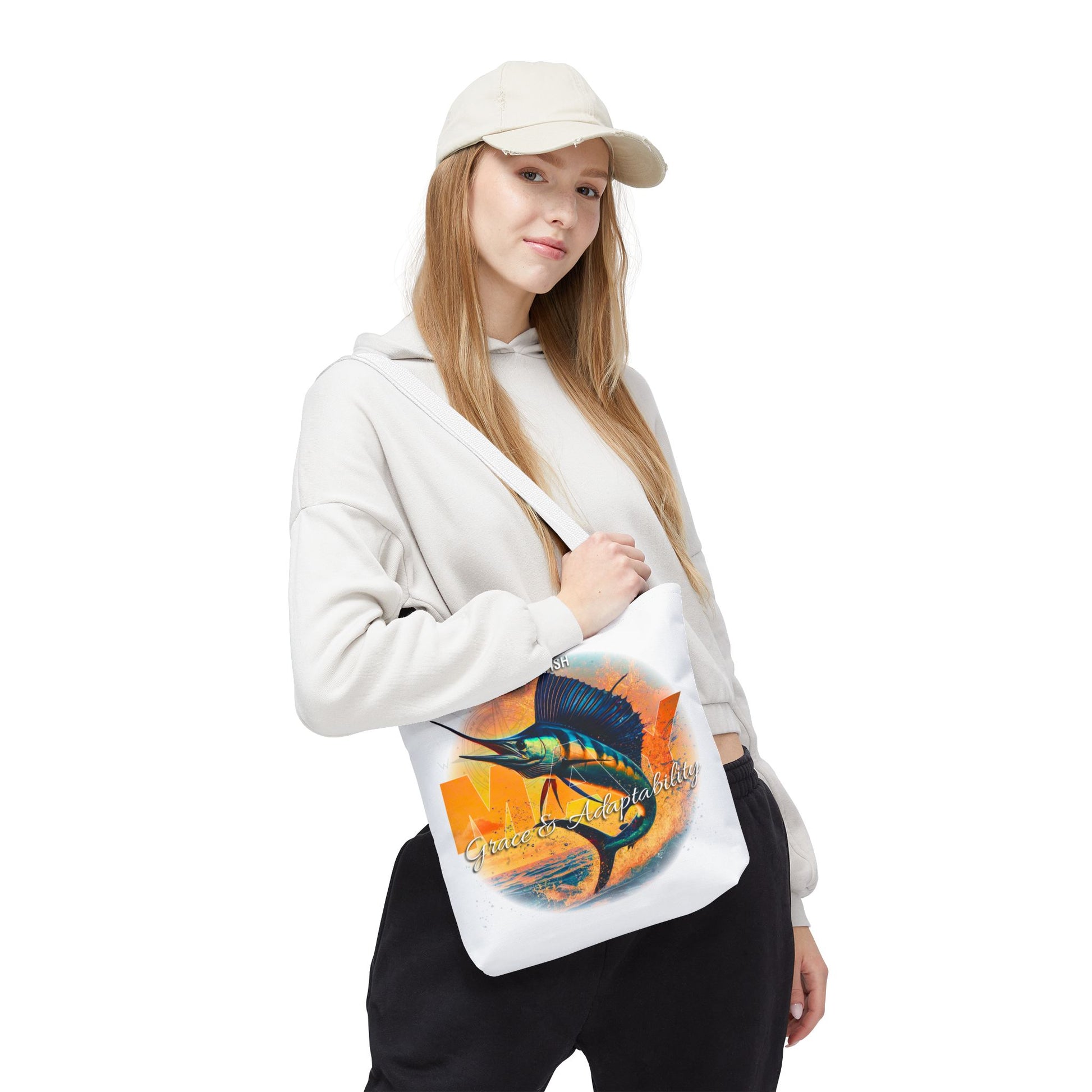 Birth month beach tote with colorful fish design worn by woman in casual outfit