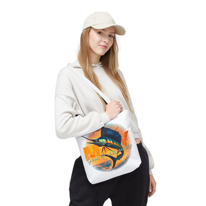 Birth month beach tote with colorful fish design worn by woman in casual outfit