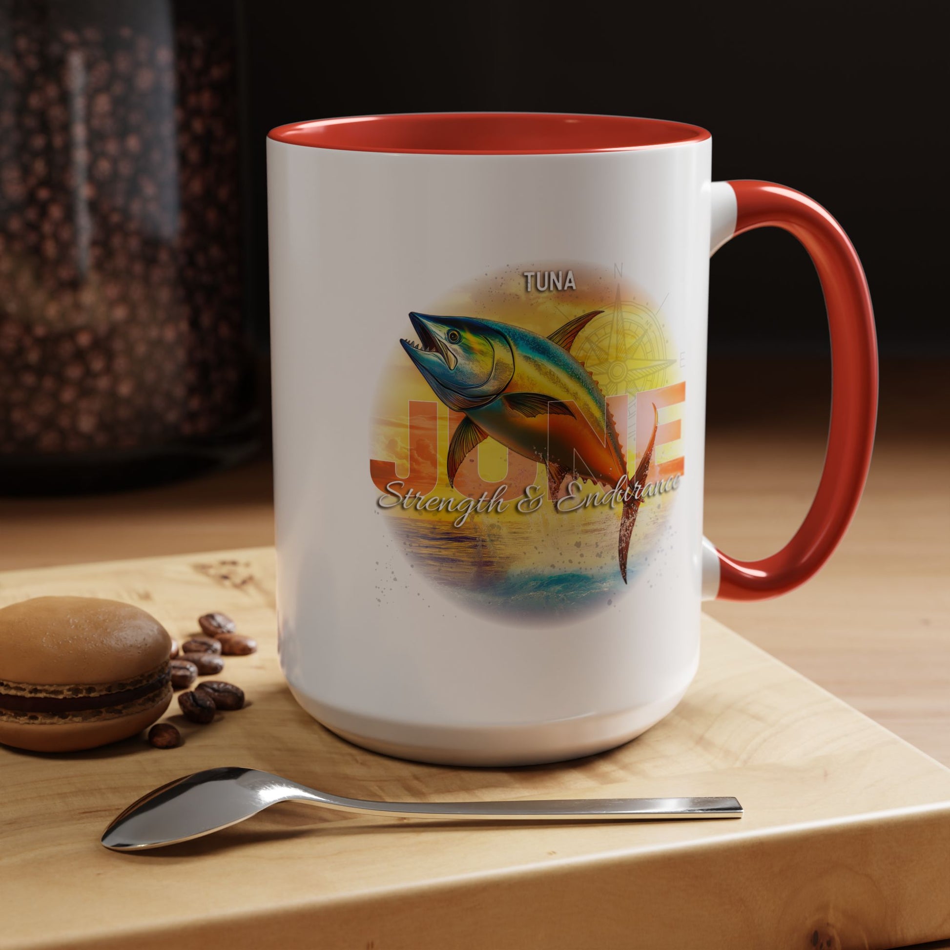 Birth month coffee mug with tuna fish design and red handle on wooden surface