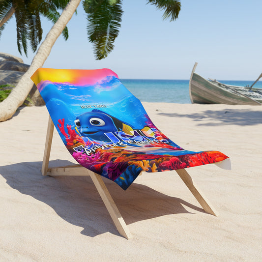 Colorful birth month kids beach towel with animated fish design on wooden beach chair