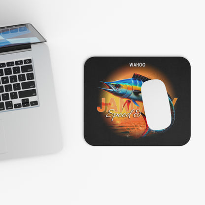 Wahoo print birth month mouse pad with colorful fish design next to laptop