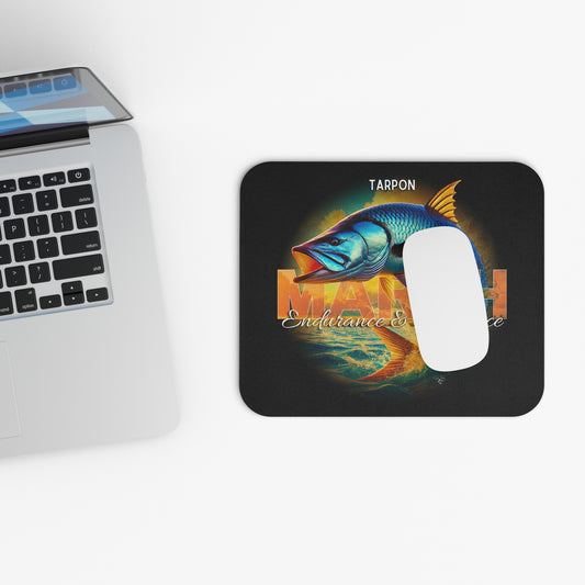 Birth month mouse pad featuring colorful tarpon fish design next to a laptop keyboard