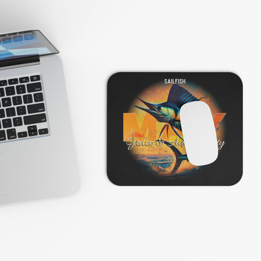 Birth month mouse pad featuring a sailfish design next to a laptop and white mouse