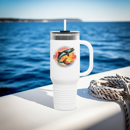 Birth month travel mug with colorful fish design on white insulated cup by the water