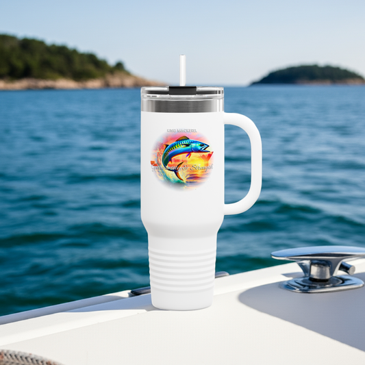 White birth month travel mug with a colorful fish design on a boat near the water