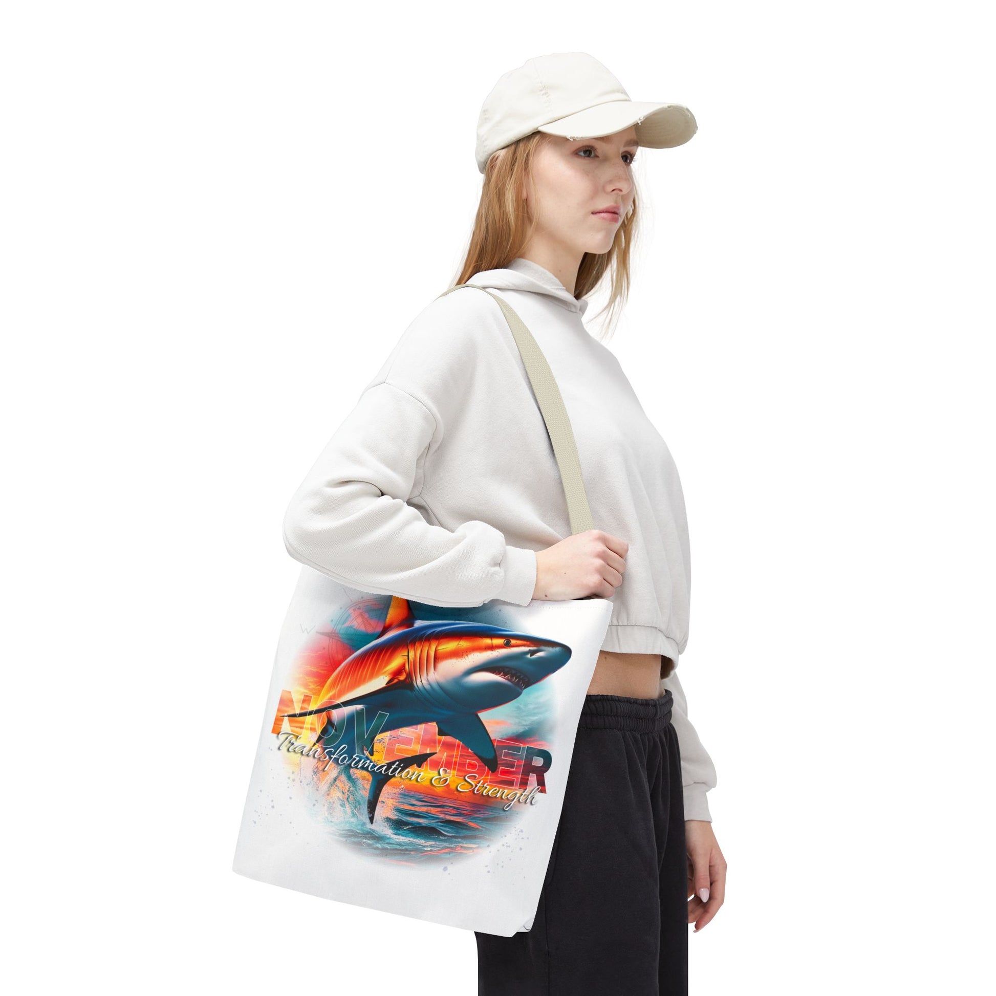Woman carrying birth month beach tote with colorful shark design and text on white background