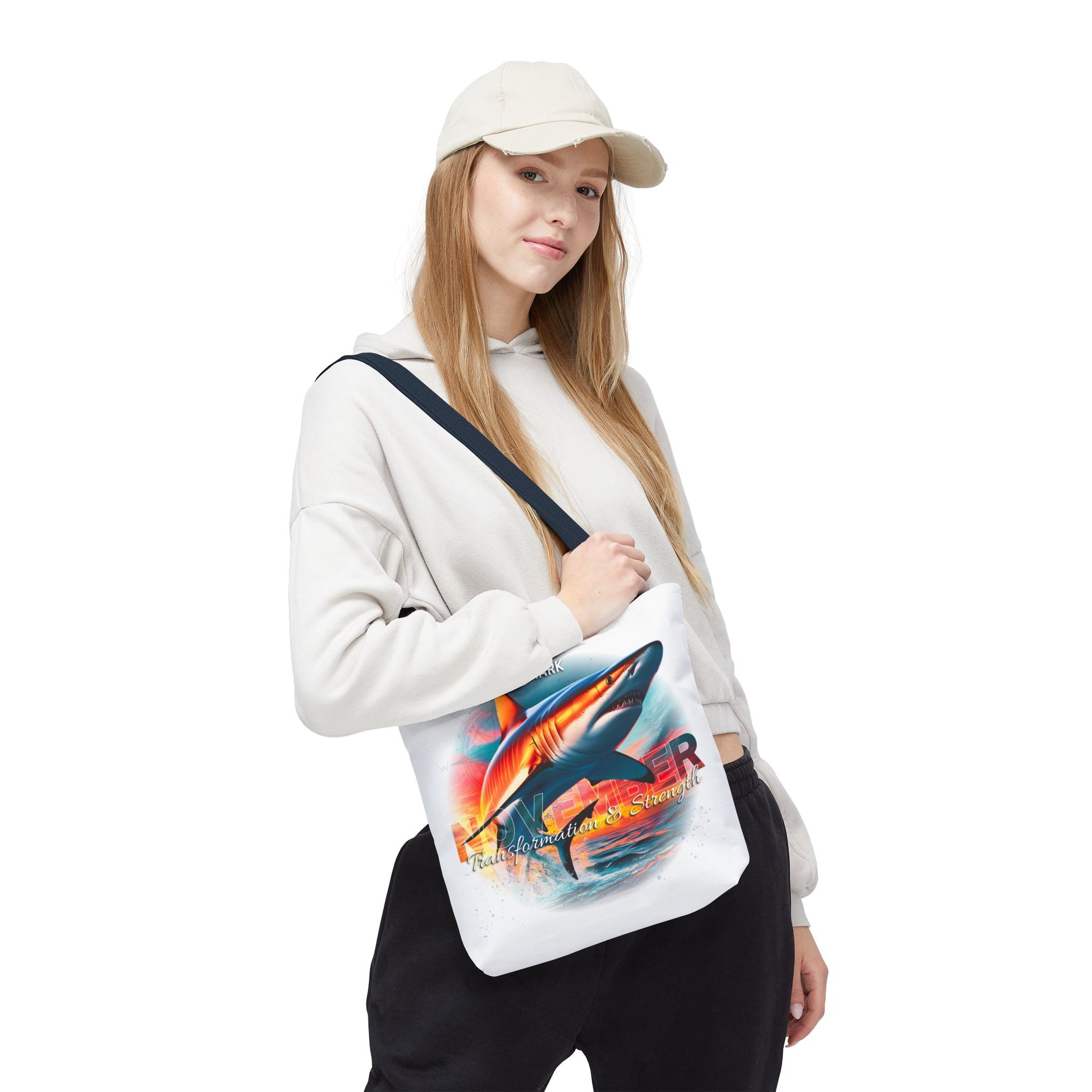Birth month beach tote with colorful shark design worn by a woman in casual outfit