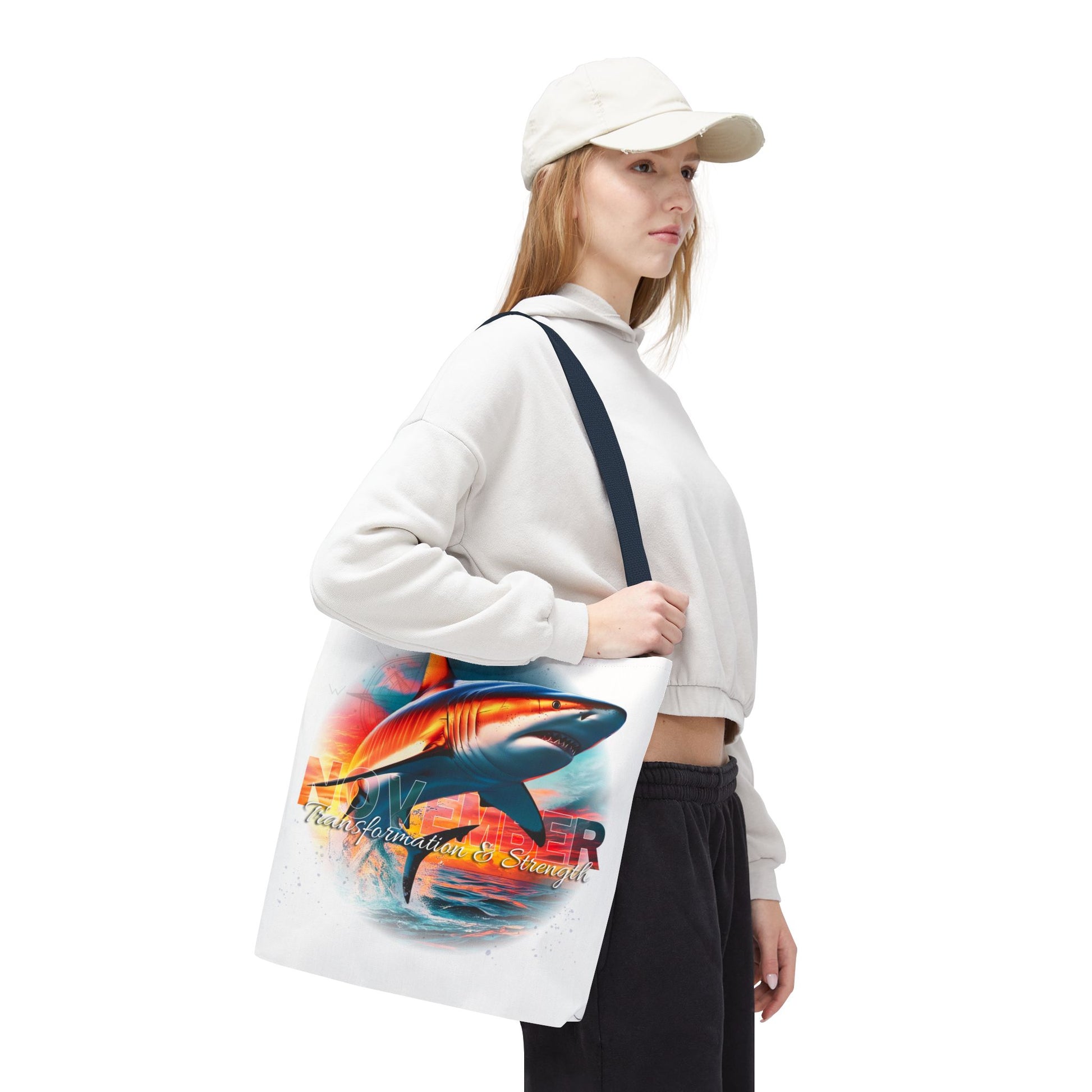 Woman carrying birth month beach tote with colorful shark design on white background