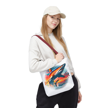 Woman wearing white cap carrying a birth month beach tote with colorful shark design and maroon strap