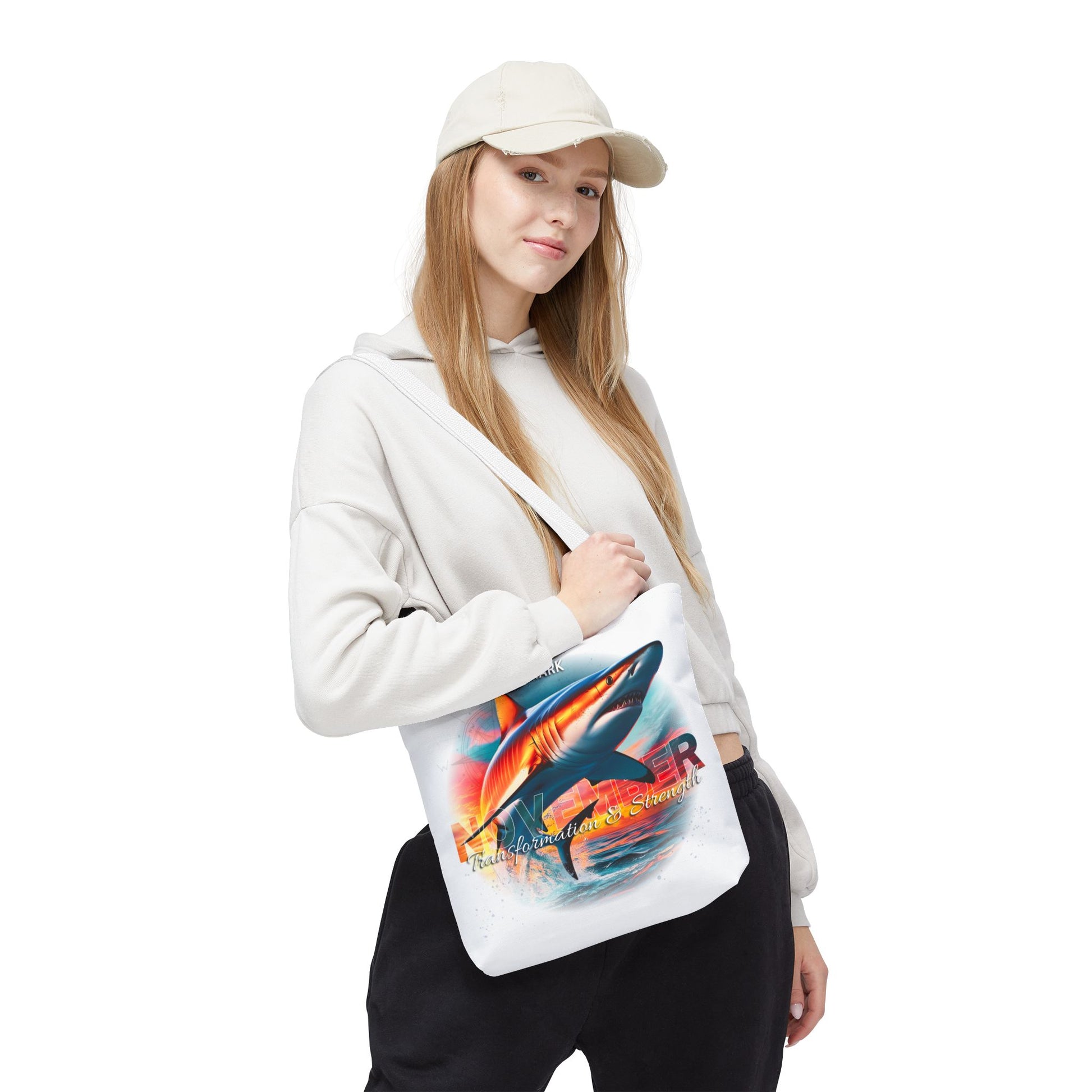 Young woman wearing a birth month beach tote with colorful shark design over shoulder