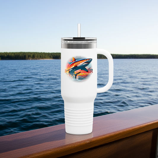White birth month travel mug with shark design and clear lid on wooden railing by water